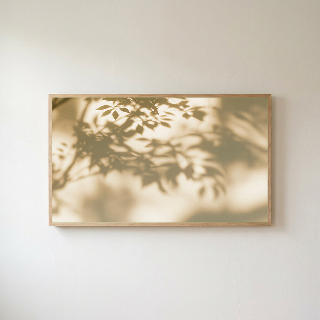 Leaf shadow Frame TV art in an oak frame on a warm white wall