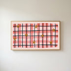 Gingham plaid with stars Frame TV art in an oak frame on a warm white wall