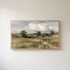 Countryside meadow and cottage Frame TV art in an oak frame on a warm white wall