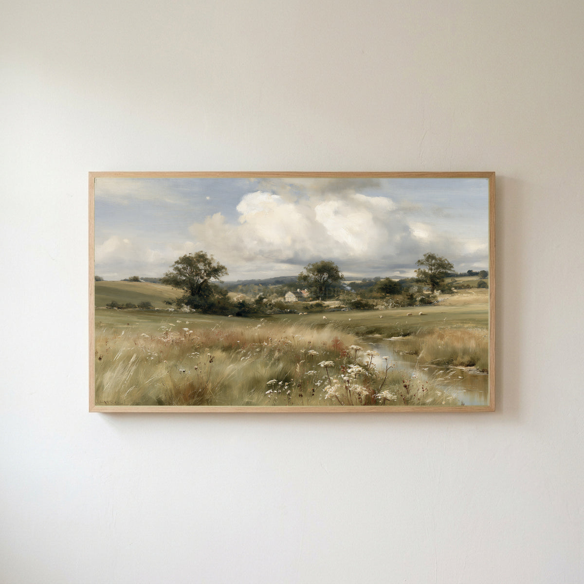 Countryside meadow and cottage Frame TV art in an oak frame on a warm white wall