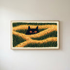 Black cat in grass Frame TV art in an oak frame on a warm white wall