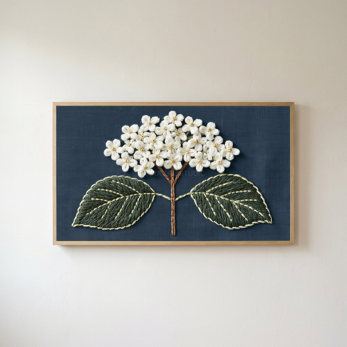 Embroidered hydrangea Frame TV art in an oak frame on a warm white wall