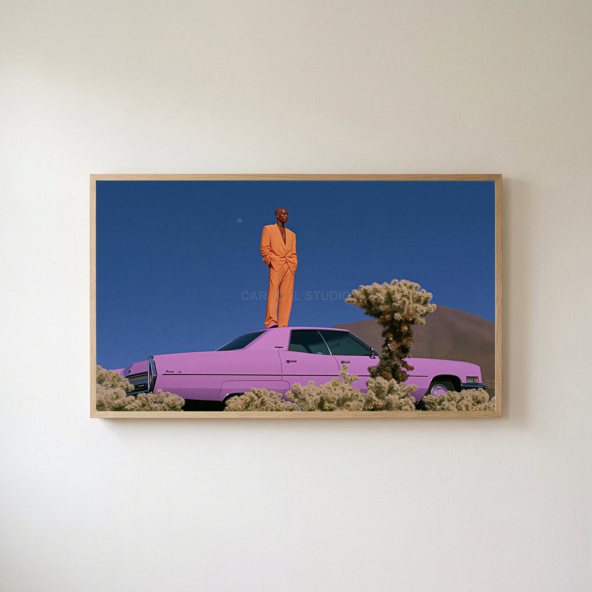 Pink car in the desert Frame TV art in an oak frame on a warm white wall