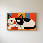 Winking black and white cat Frame TV art in an oak frame on a warm white wall