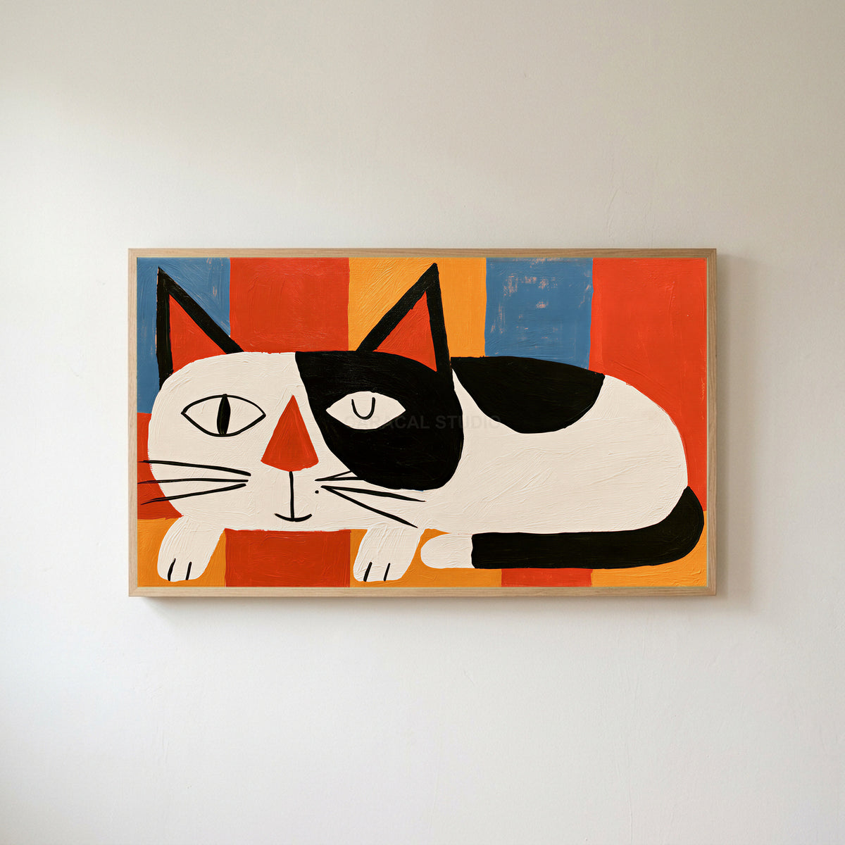 Winking black and white cat Frame TV art in an oak frame on a warm white wall