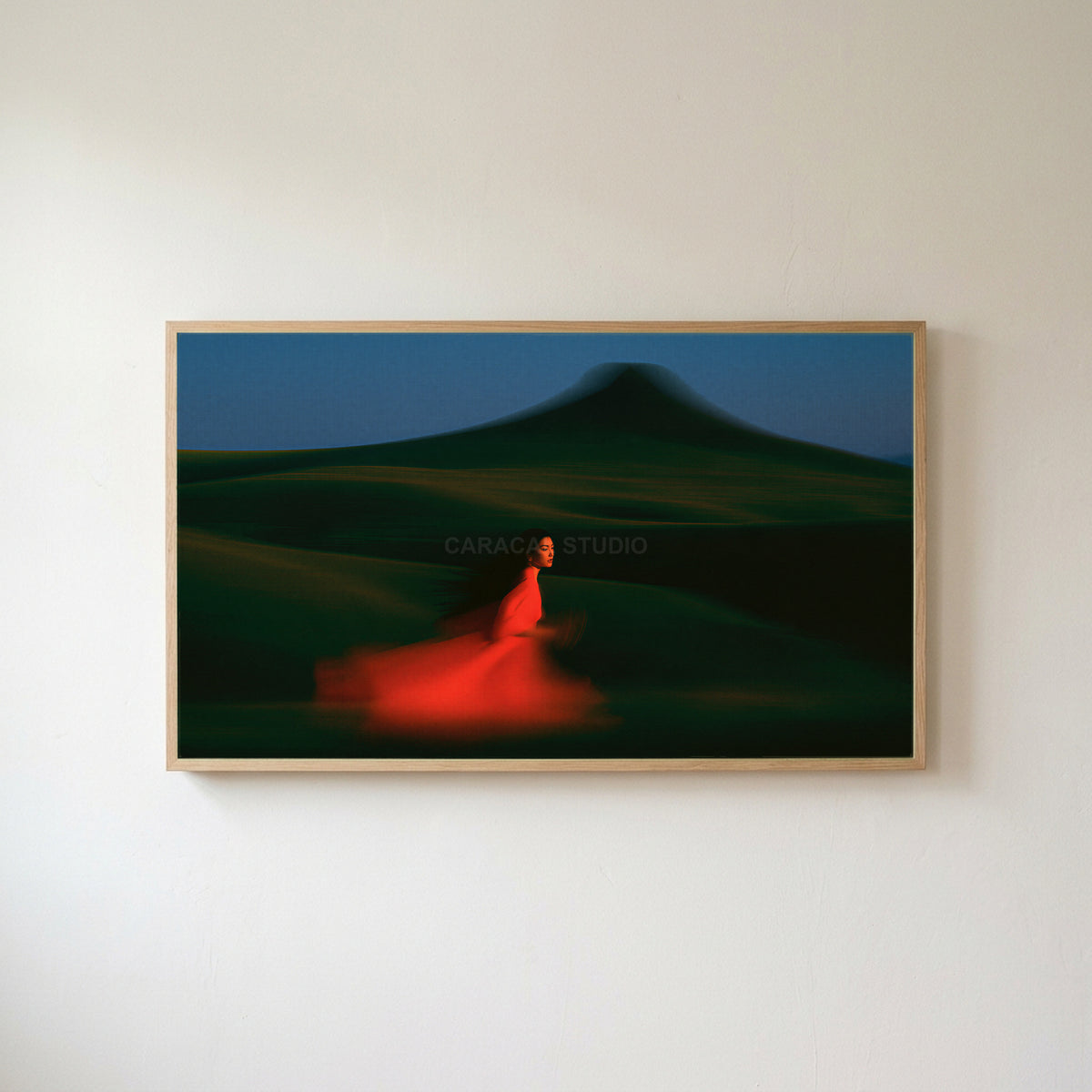 Woman running over green hills Frame TV art in an oak frame on a warm white wall