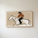 Cowboy on a horse Frame TV art in an oak frame on a warm white wall
