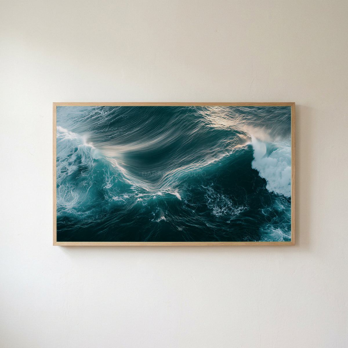 Aerial ocean waves Frame TV art in an oak frame on a warm white wall