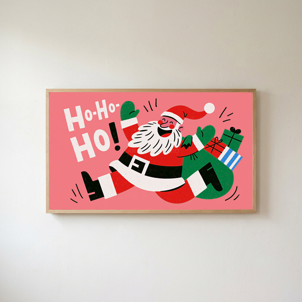 Jumping Santa Frame TV art in an oak frame on a warm white wall