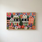 Folk art Christmas village Frame TV art in an oak frame on a warm white wall