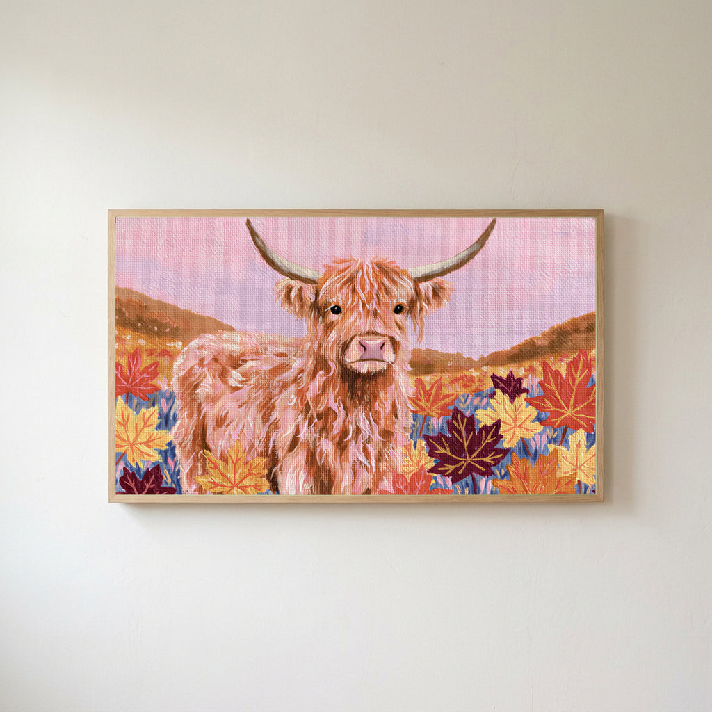 Highland cow in fall leaves Frame TV art in an oak frame on a warm white wall