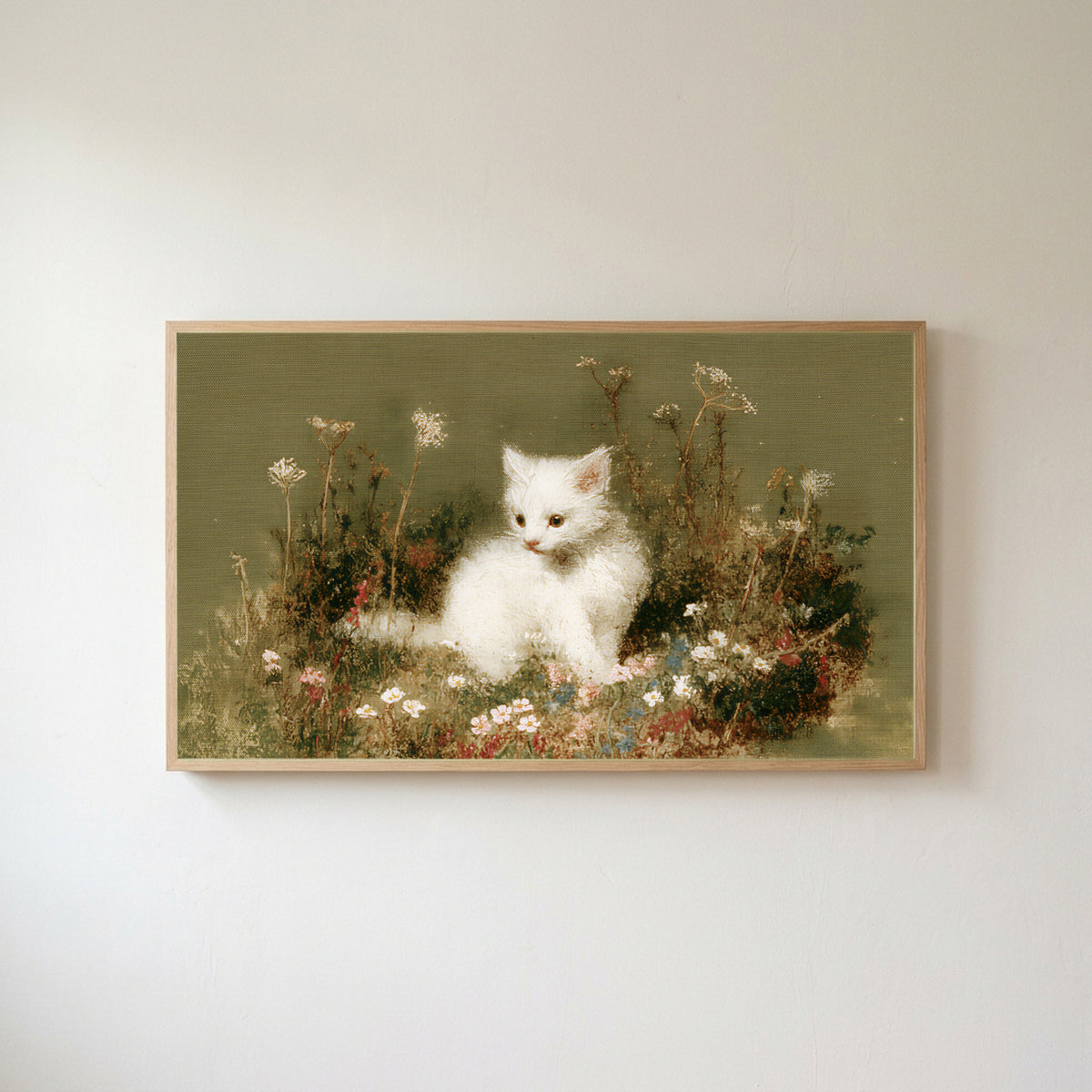 White kitten Frame TV art in an oak frame on a warm white wall