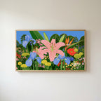 Tropical flower garden Frame TV art in an oak frame on a warm white wall