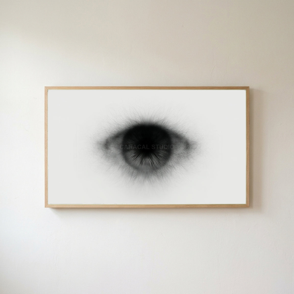 Black and white eye Frame TV art in an oak frame on a warm white wall