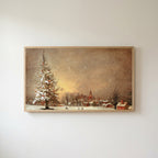 Snowy tree and village Frame TV art in an oak frame on a warm white wall