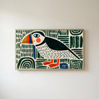 Folk art puffin Frame TV art in an oak frame on a warm white wall