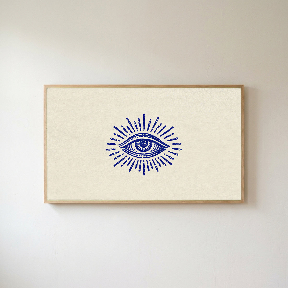 Mystic eye Frame TV art in an oak frame on a warm white wall