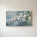 Hydrangea Frame TV art in an oak frame on a warm white wall