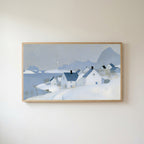 Snowy seaside village Frame TV art in an oak frame on a warm white wall