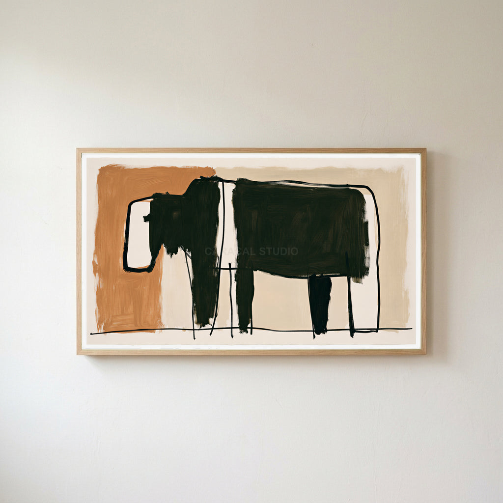 Minimalist black cow Frame TV art in an oak frame on a warm white wall