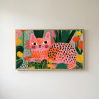 Spotted cat Frame TV art in an oak frame on a warm white wall