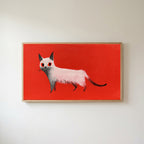White cat Frame TV art in an oak frame on a warm white wall