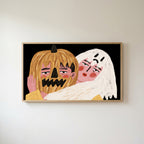 Jack-o'-lantern and ghost Frame TV art in an oak frame on a warm white wall