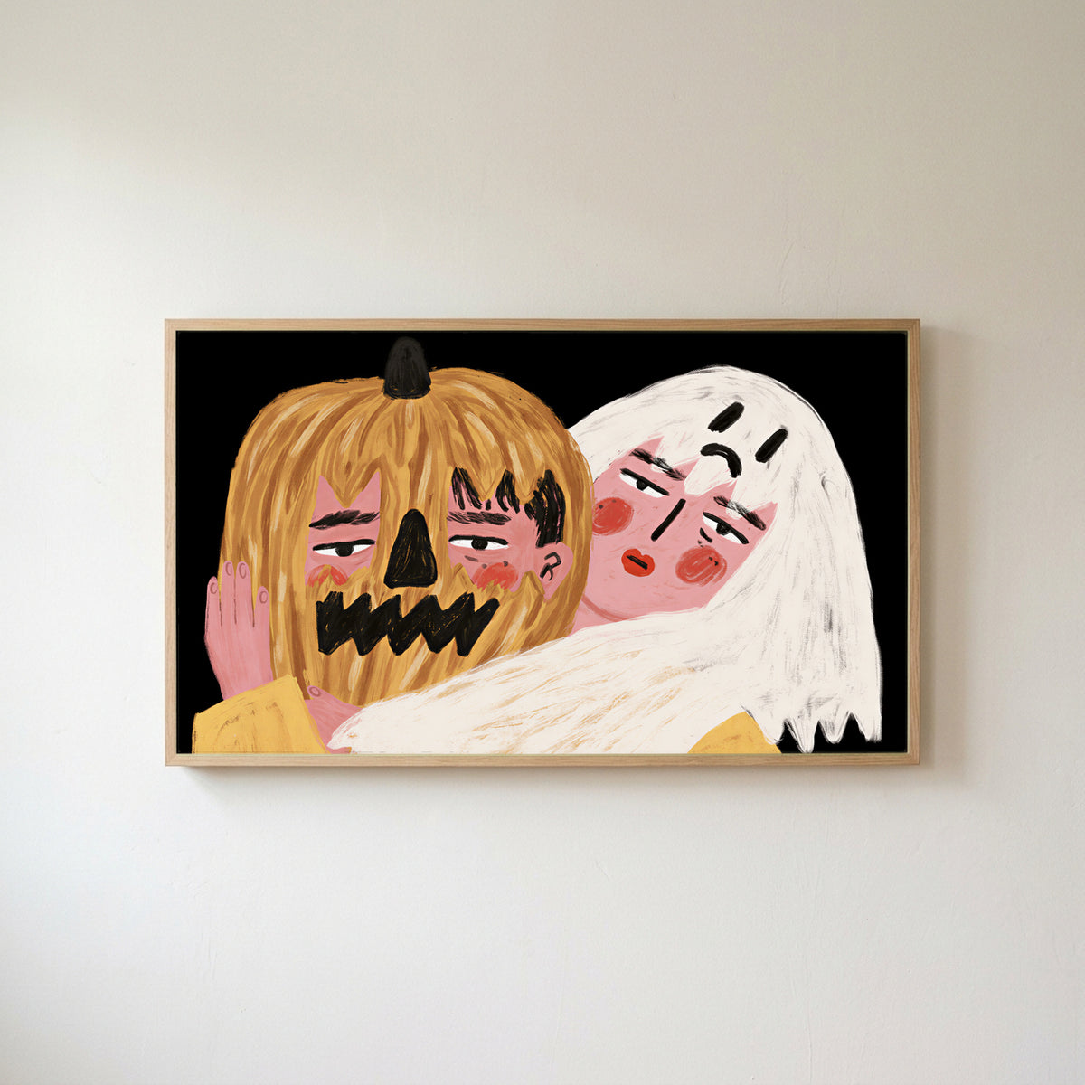 Jack-o'-lantern and ghost Frame TV art in an oak frame on a warm white wall