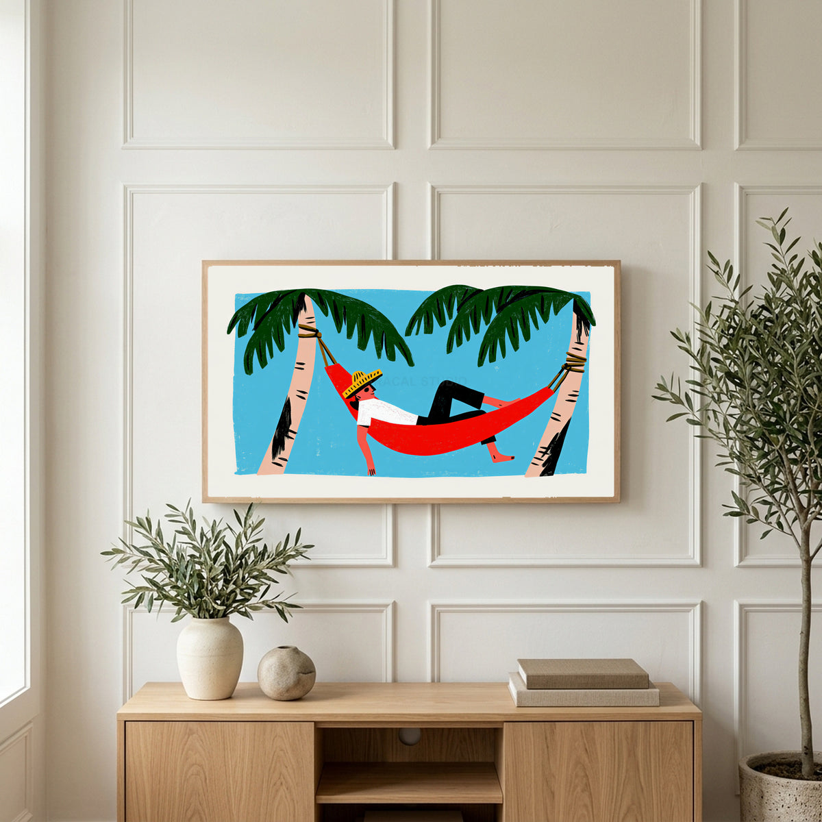 Hammock art on a TV above a light oak sideboard with olive branches in a bright living room