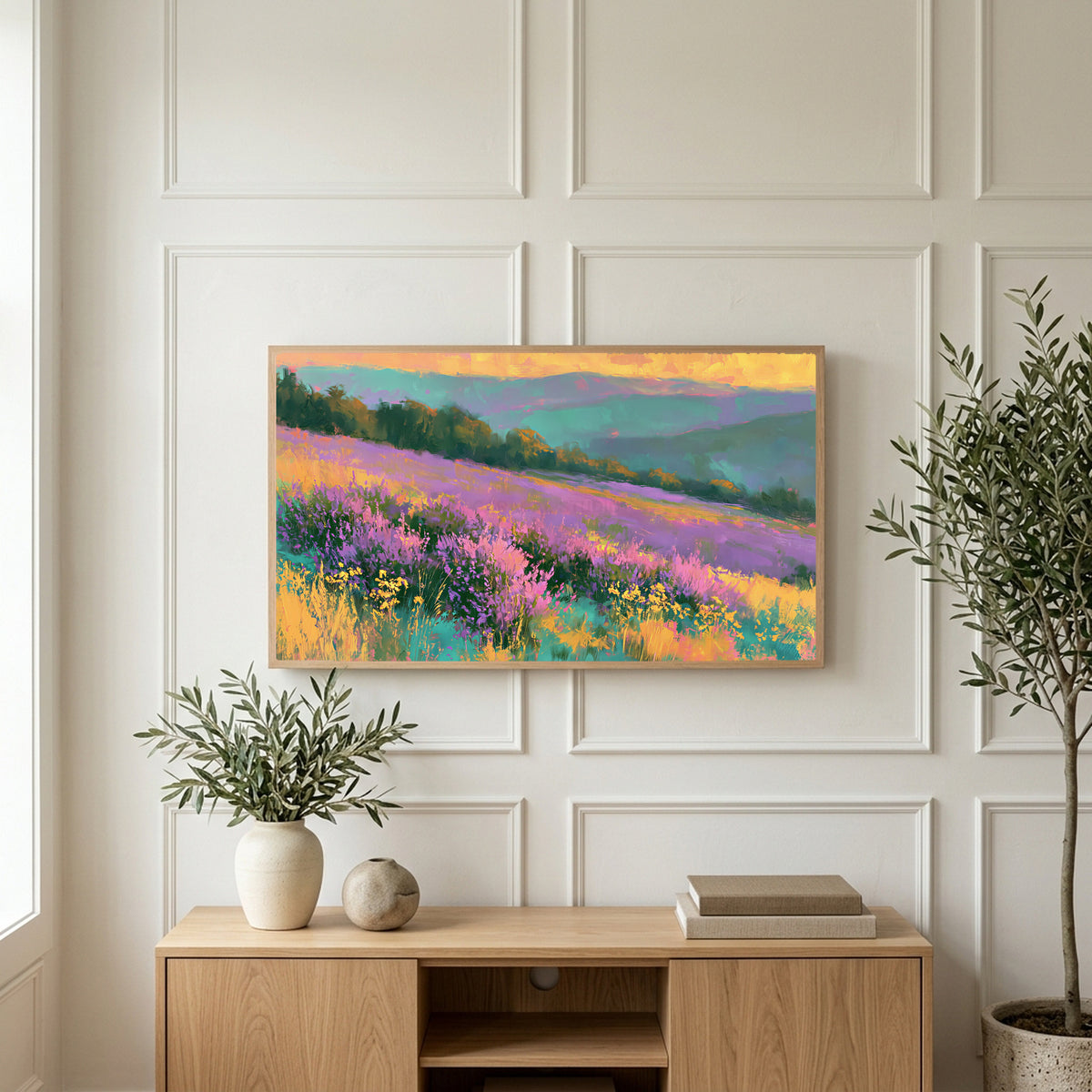Heather hills art on a TV above a light oak sideboard with olive branches in a bright living room