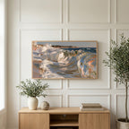 Crashing ocean waves art on a TV above a light oak sideboard with olive branches in a bright living room