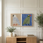 Polka dot birds art on a TV above a light oak sideboard with olive branches in a bright living room