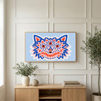 Three-eyed wolf art on a TV above a light oak sideboard with olive branches in a bright living room