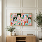 Faceless portraits art on a TV above a light oak sideboard with olive branches in a bright living room