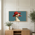 Duck in a red hat art on a TV above a light oak sideboard with olive branches in a bright living room