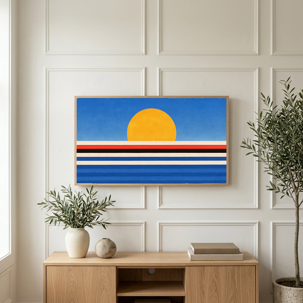 Retro sunset over the sea art on a TV above a light oak sideboard with olive branches in a bright living room