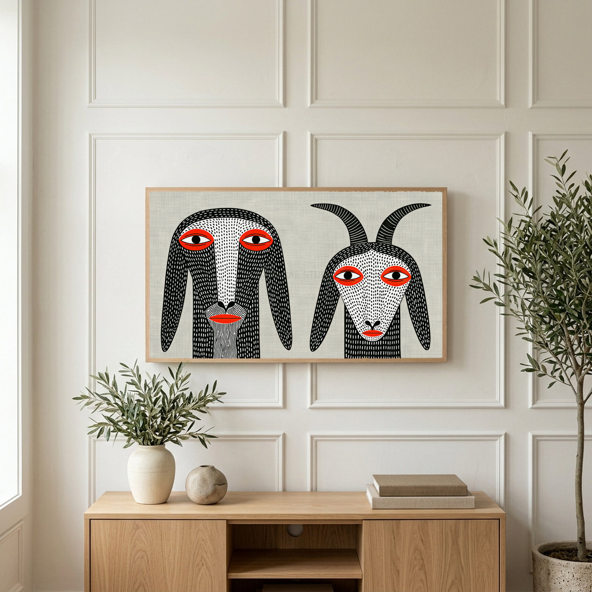 Folk art goats art on a TV above a light oak sideboard with olive branches in a bright living room