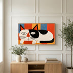 Winking black and white cat art on a TV above a light oak sideboard with olive branches in a bright living room
