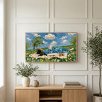 Picnic reader in a meadow art on a TV above a light oak sideboard with olive branches in a bright living room