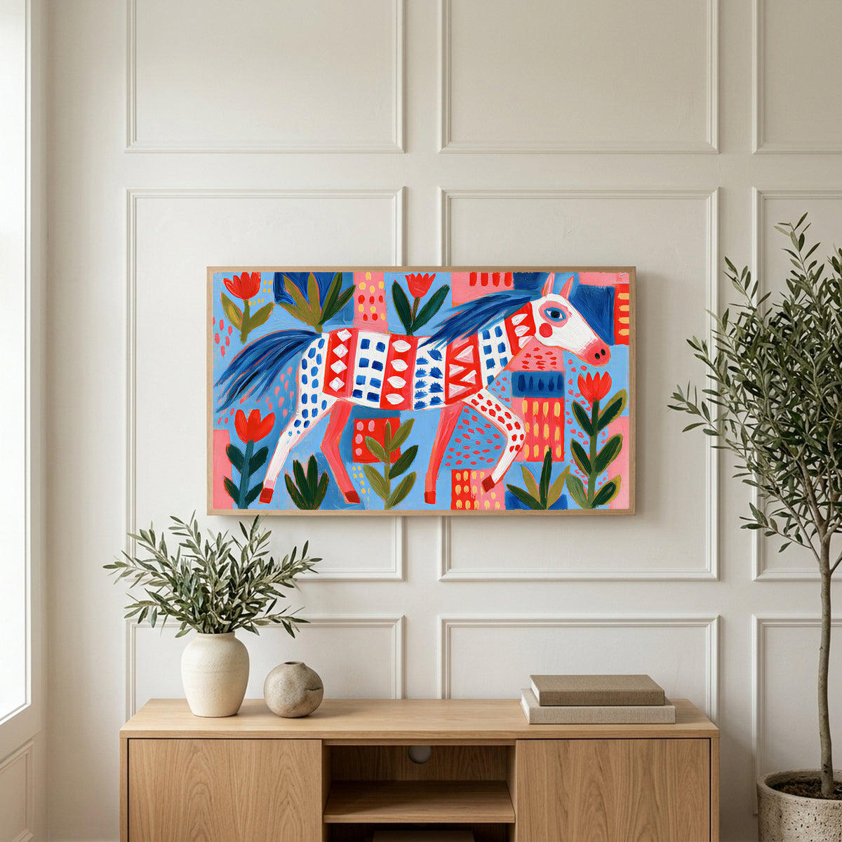 Folk art horse art on a TV above a light oak sideboard with olive branches in a bright living room