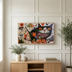 Grinning black cat art on a TV above a light oak sideboard with olive branches in a bright living room