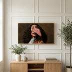Funny baroque portrait art on a TV above a light oak sideboard with olive branches in a bright living room
