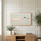 Cat and whale art on a TV above a light oak sideboard with olive branches in a bright living room