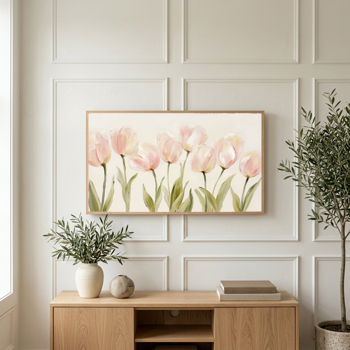 Pink tulip art on a TV above a light oak sideboard with olive branches in a bright living room