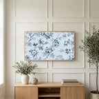 Toile wild roses art on a TV above a light oak sideboard with olive branches in a bright living room
