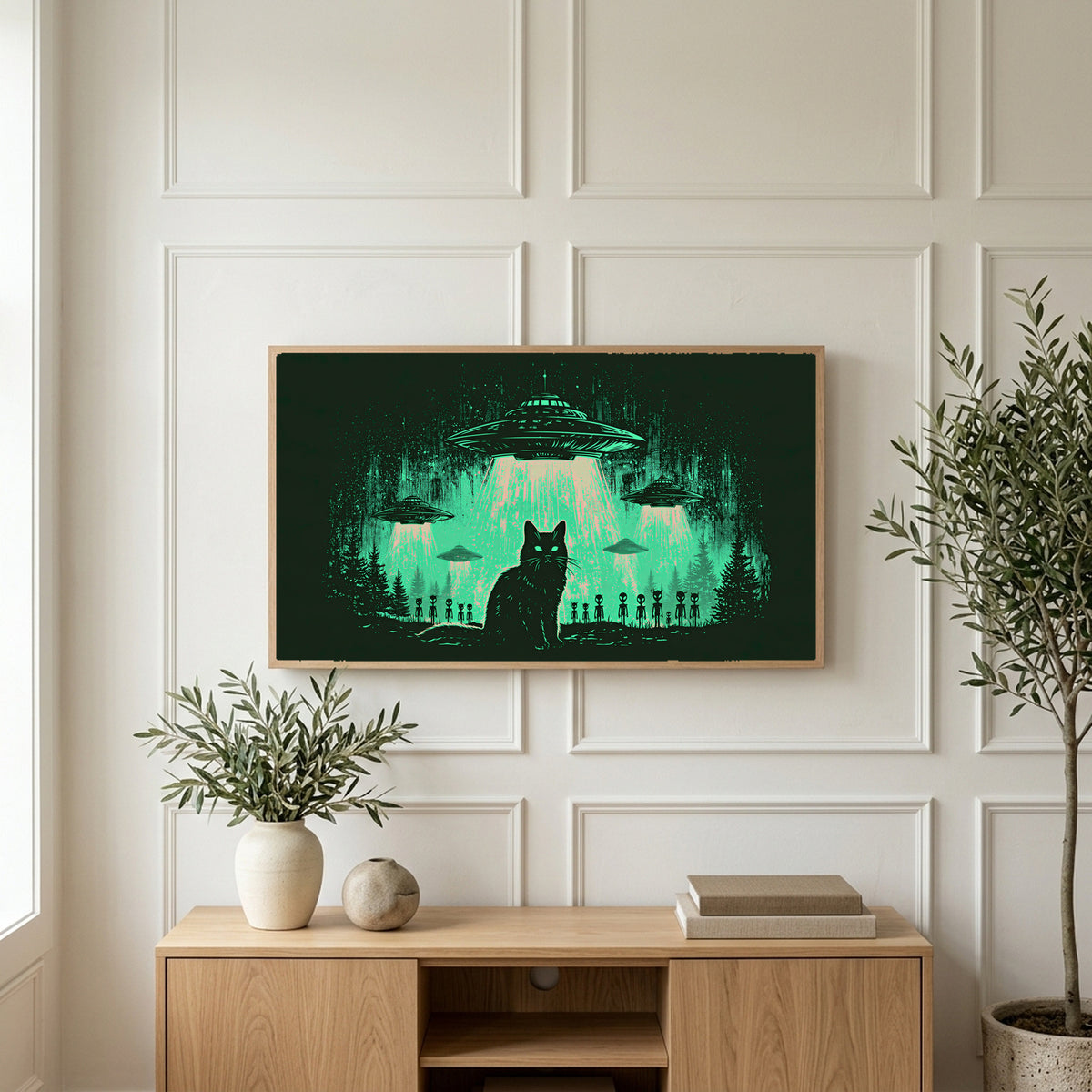 Black cat UFO art on a TV above a light oak sideboard with olive branches in a bright living room