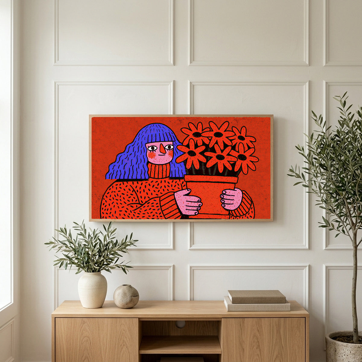 Blue hair portrait art on a TV above a light oak sideboard with olive branches in a bright living room