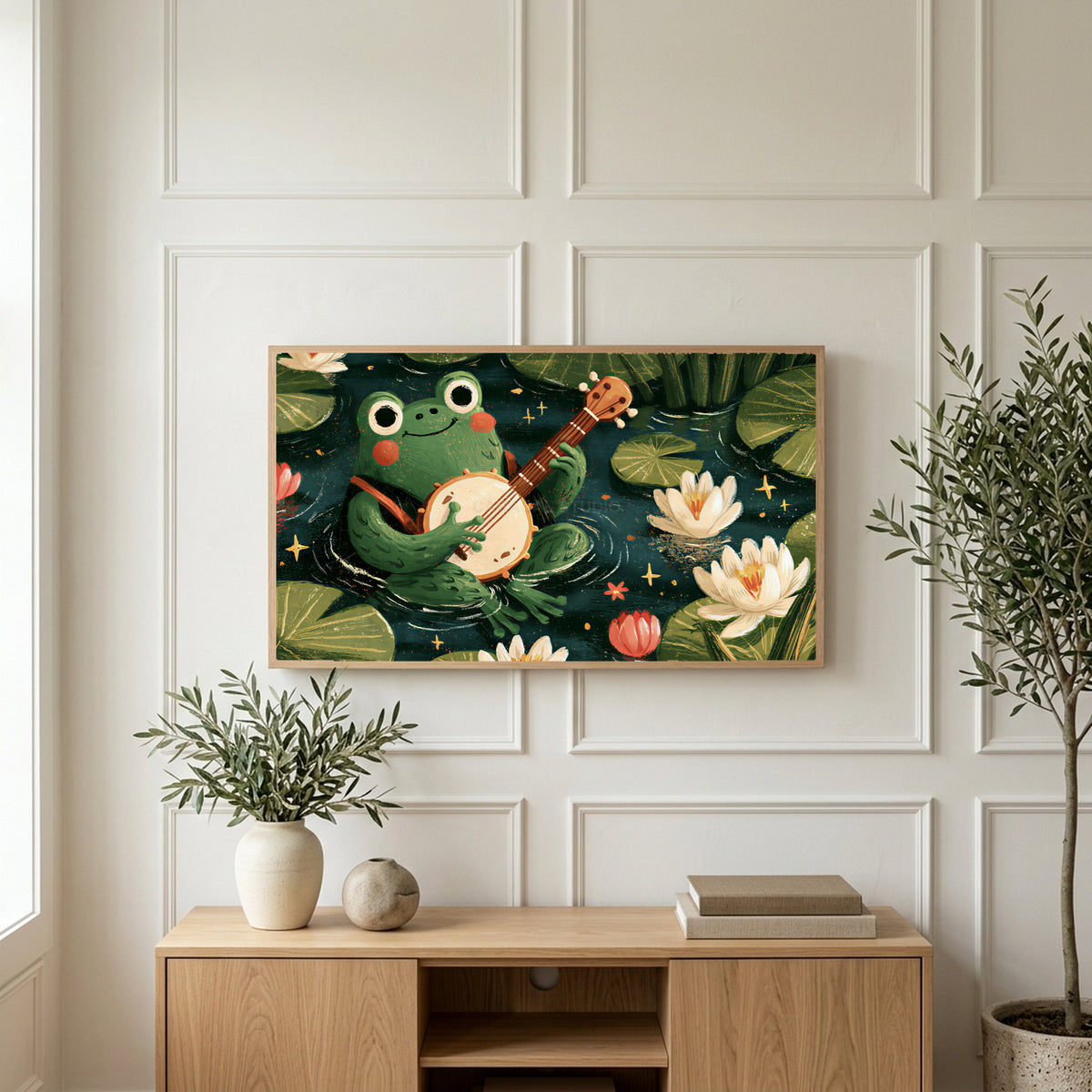 Frog playing a banjo art on a TV above a light oak sideboard with olive branches in a bright living room
