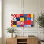 Polka dot patchwork art on a TV above a light oak sideboard with olive branches in a bright living room