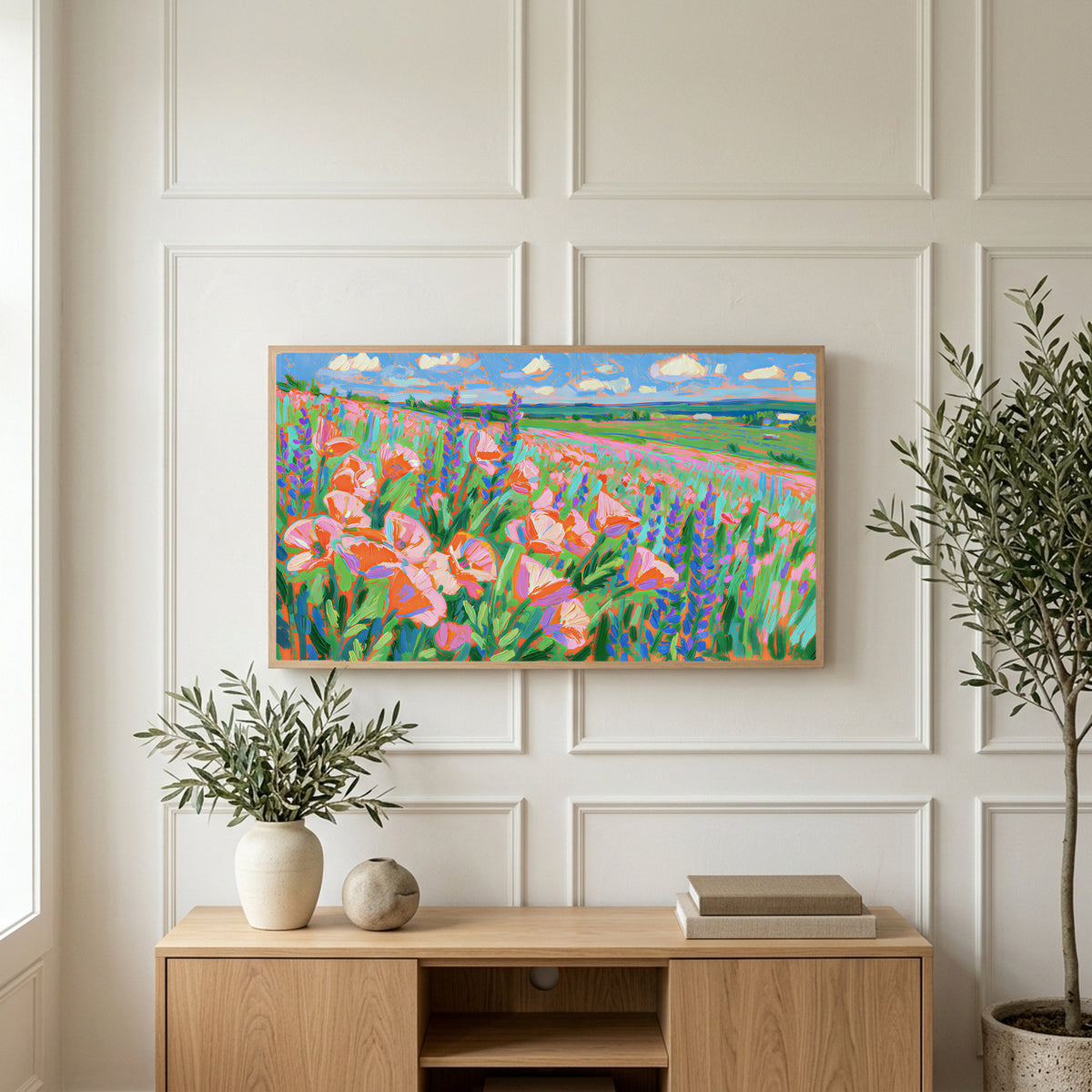 Poppy field art on a TV above a light oak sideboard with olive branches in a bright living room